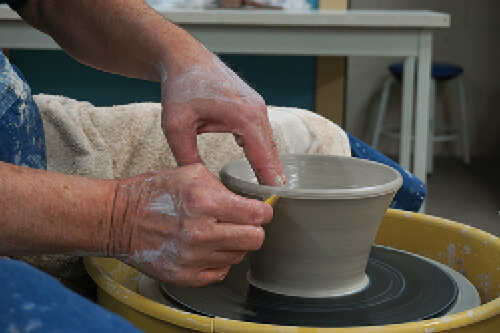 Ceramist spins clay on pottery wheel