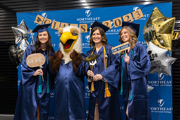 NWTC Graduates pose with the eagle after the ceremony