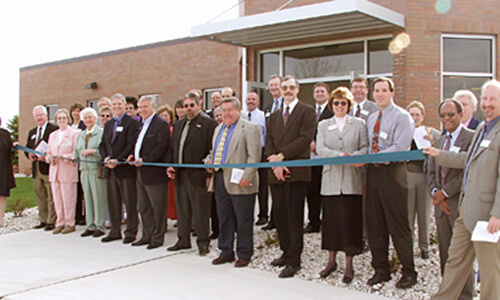 Ribbon cutting with group of people in front of building