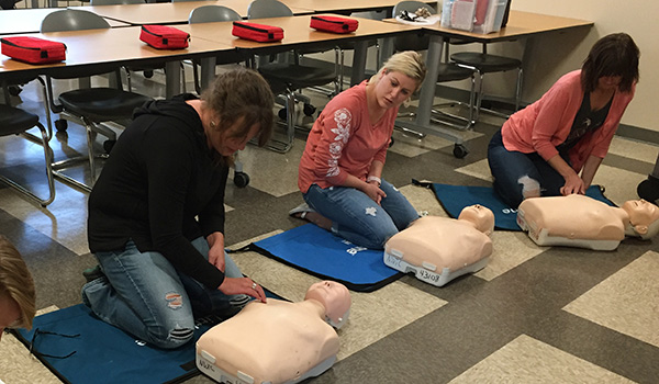 Students learn CPR during a community class