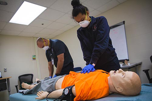 Emergency Medical Technician students performing CPR