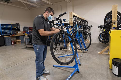 Student works on a row of bicycles