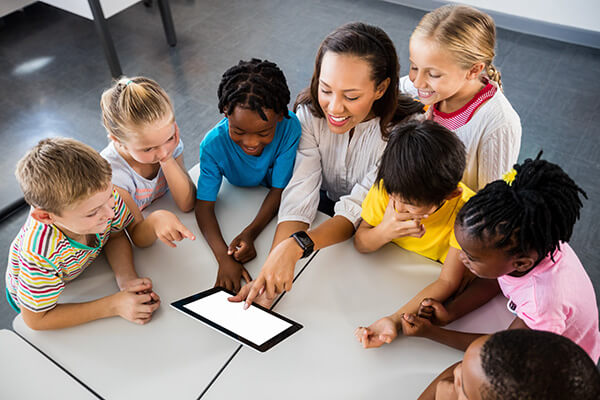 A teacher works with young children in a classroom