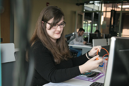 A student works with networking hardware