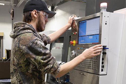 A student works on a CNC machine