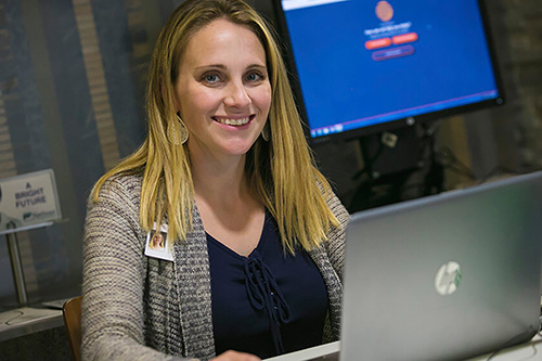 A human resources worker greets new employees