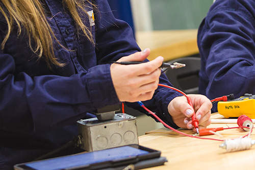 A student works on an electrical box