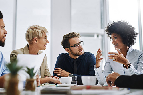 Staff members meet in a borad room