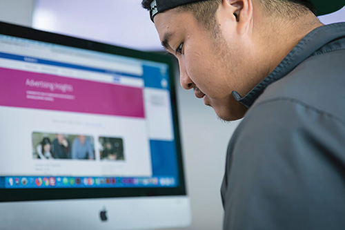 A student works on a Mac