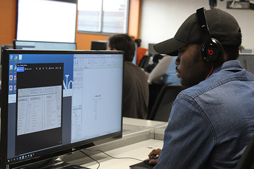 An Architectural student works on a plan on a computer