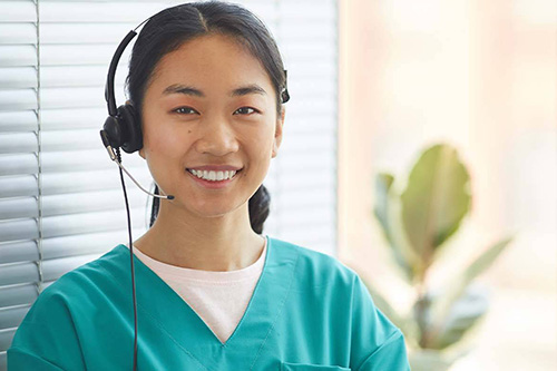 A nurse wears a headset 