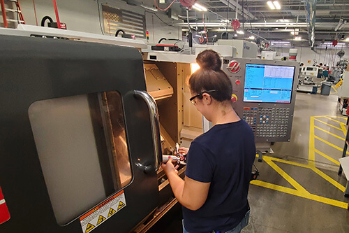 A female student works on a machine