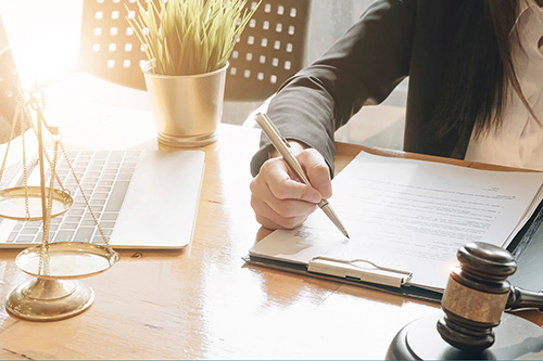 A lawyer reviews paperwork on a clipboard