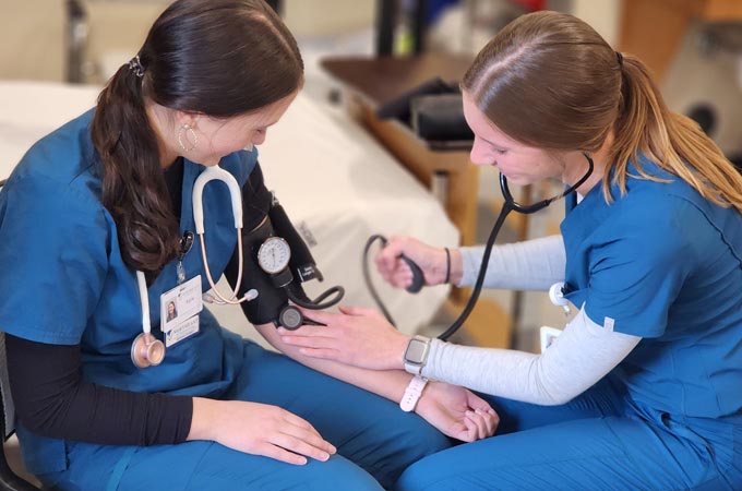 A nurse takes a person's blood pressure