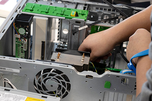 A student adds hardware to a computer