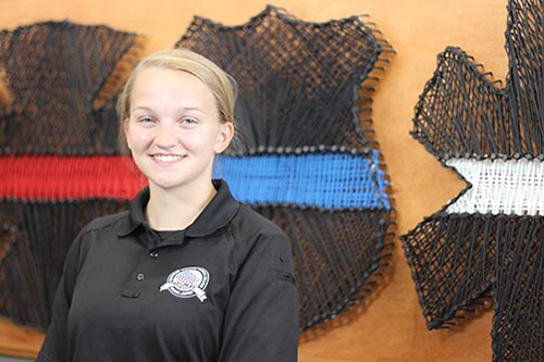 A student stands in a security uniform