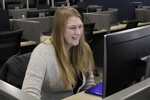 A student works on a computer in a lab