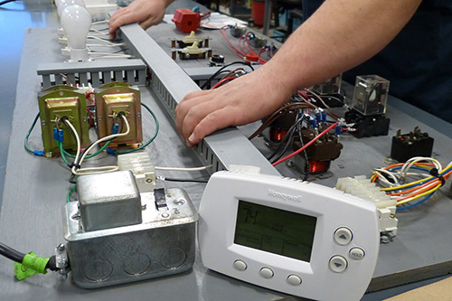 A student works on a simulated heating system