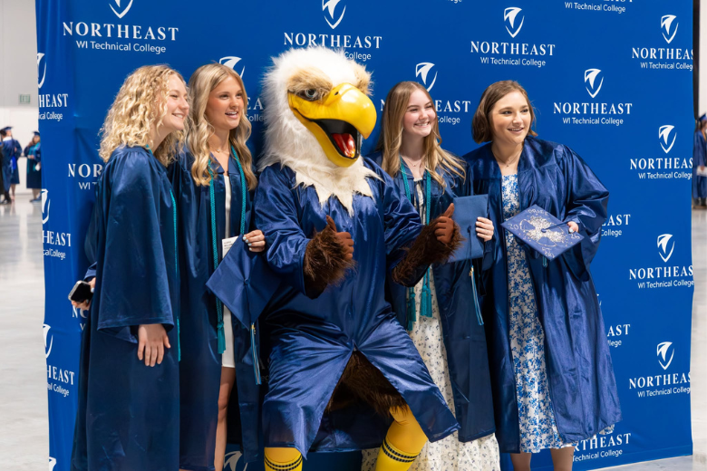 Student Graduates and Newton at the Resch Center