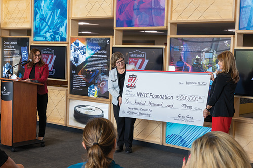 College leaders accept a donation in the Trades Atrium