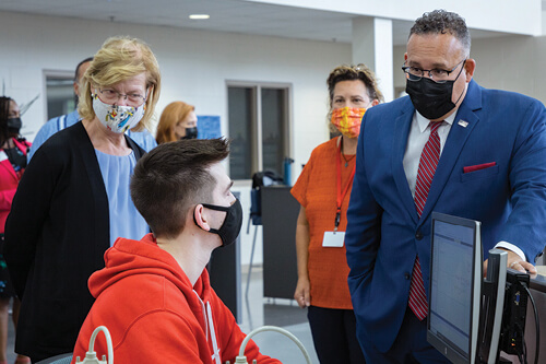 A student talks to Secretary Cardona and Senator Baldwin about NWTC’s engineering technology programs.