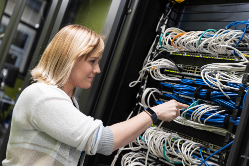 NWTC security analyst, Molly Vollrath, works on IT equipment.