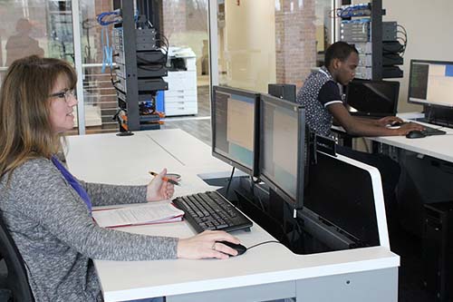 Cybersecurity students work in a computer lab