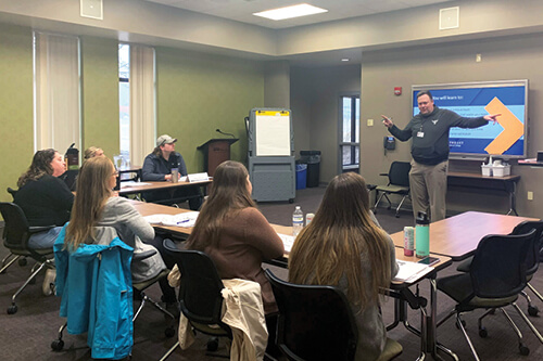 An instructor teaches a professional development course in the Corporate Conference Center