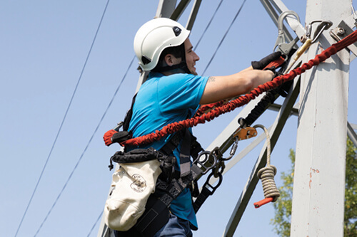 A telecomm worker adjusts a line