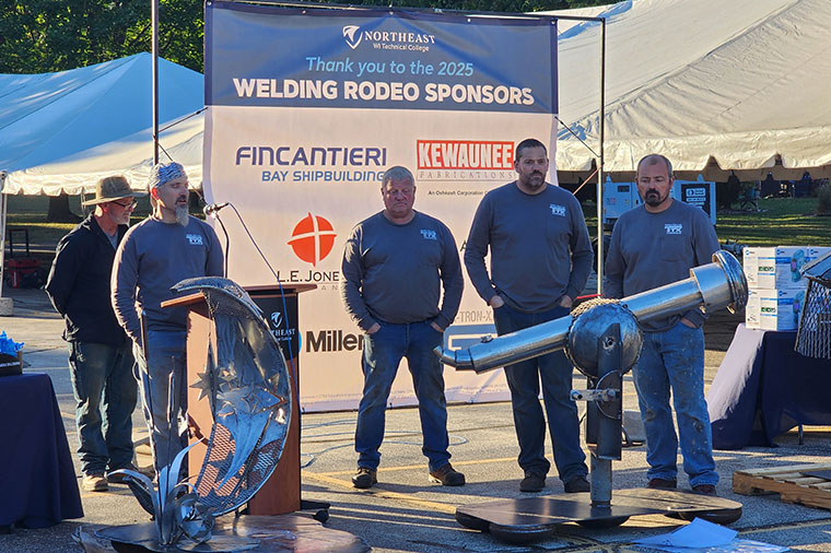Welding Rodeo teams pose with their sculptures