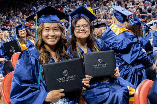 Graduates holding diplomas