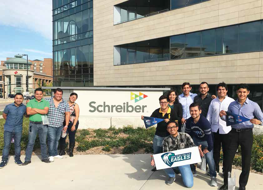 Study abroad students in front of the Schreiber sign