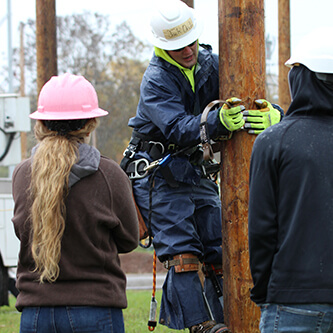 NWTC student demonstrates pole climbing.