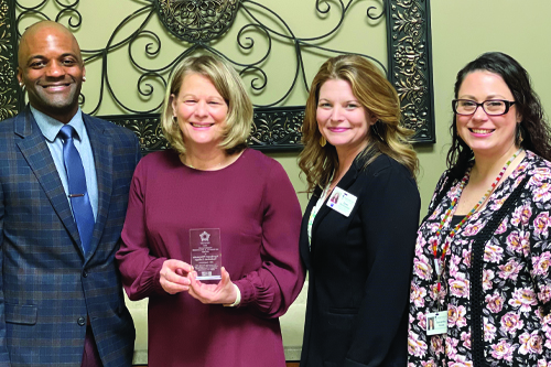 NWTC employees Mohammed Bey, Lisa Maas, Dawn Rentmeester, and Samantha Woods pose with the award. 