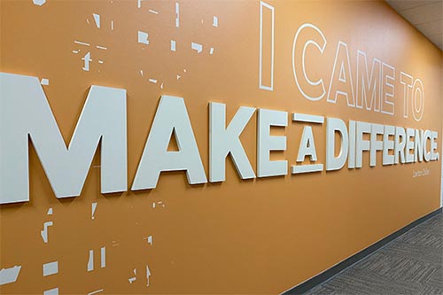 Orange wall displaying I Came to Make a Difference text