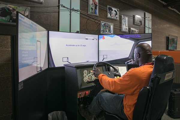 NWTC agriculture student works on simulator