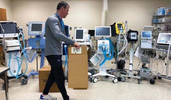 A.J. Bellile, Respiratory Therapy Program instructor, helps prepare ventilators for delivery to local health care providers to treat critically-ill patients.