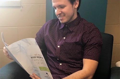 NWTC student Jesse Brauer reading a brochure