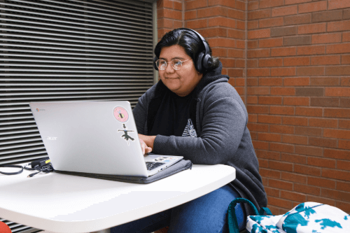 Student listening to music while studying at NWTC.