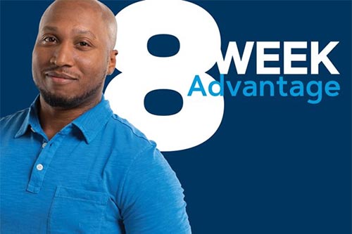 Student standing in front of 8 Week Advantage text