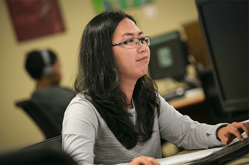 A student works on a computer in the lab.