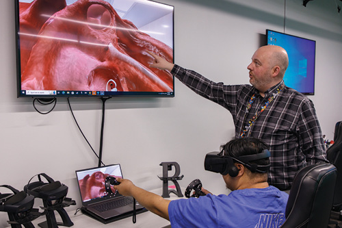 A health science instructor directs a student using extended reality