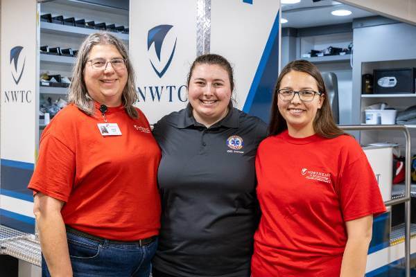EMS instructor Diana Lawler with her daughters; all are standing and smiling at the camera