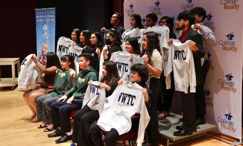 Graduates of NEW Scholars sign their acceptance letter to NWTC 