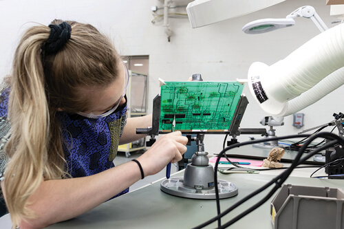 A student works on an electrical panel