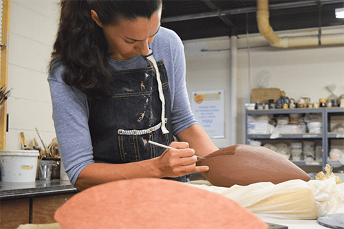  A local artisan works with clay