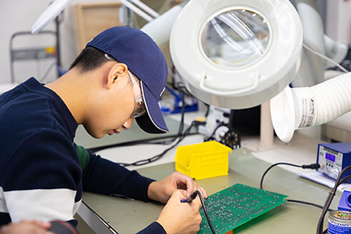 Biomedical technology student working on electronics