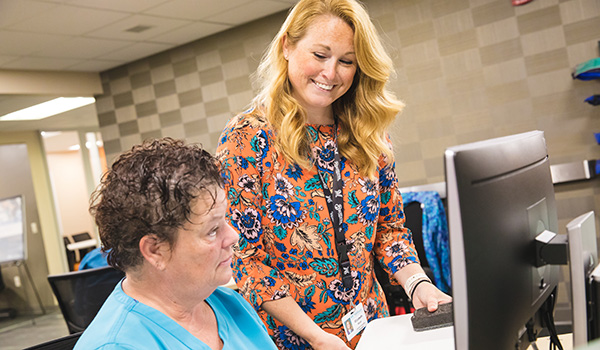 Staff member from the assessment center works with a student