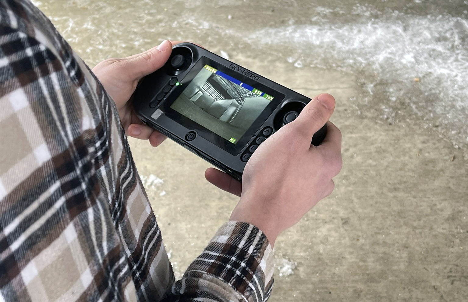 Instructor controls drone using a handheld remote