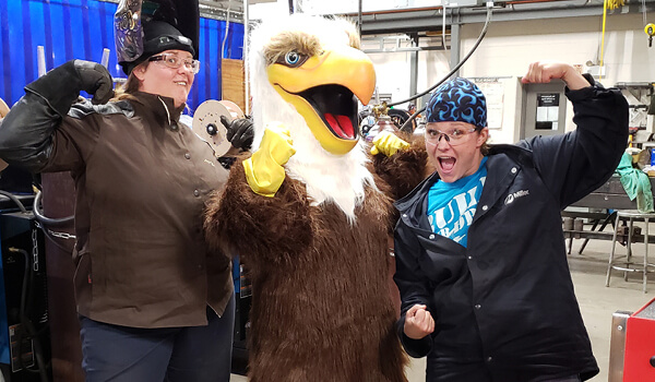 Trades students pose with the NWTC Eagle